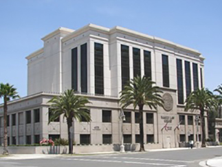 Riverside Family Law Courthouse with palm trees surrounded under a clear blue sky